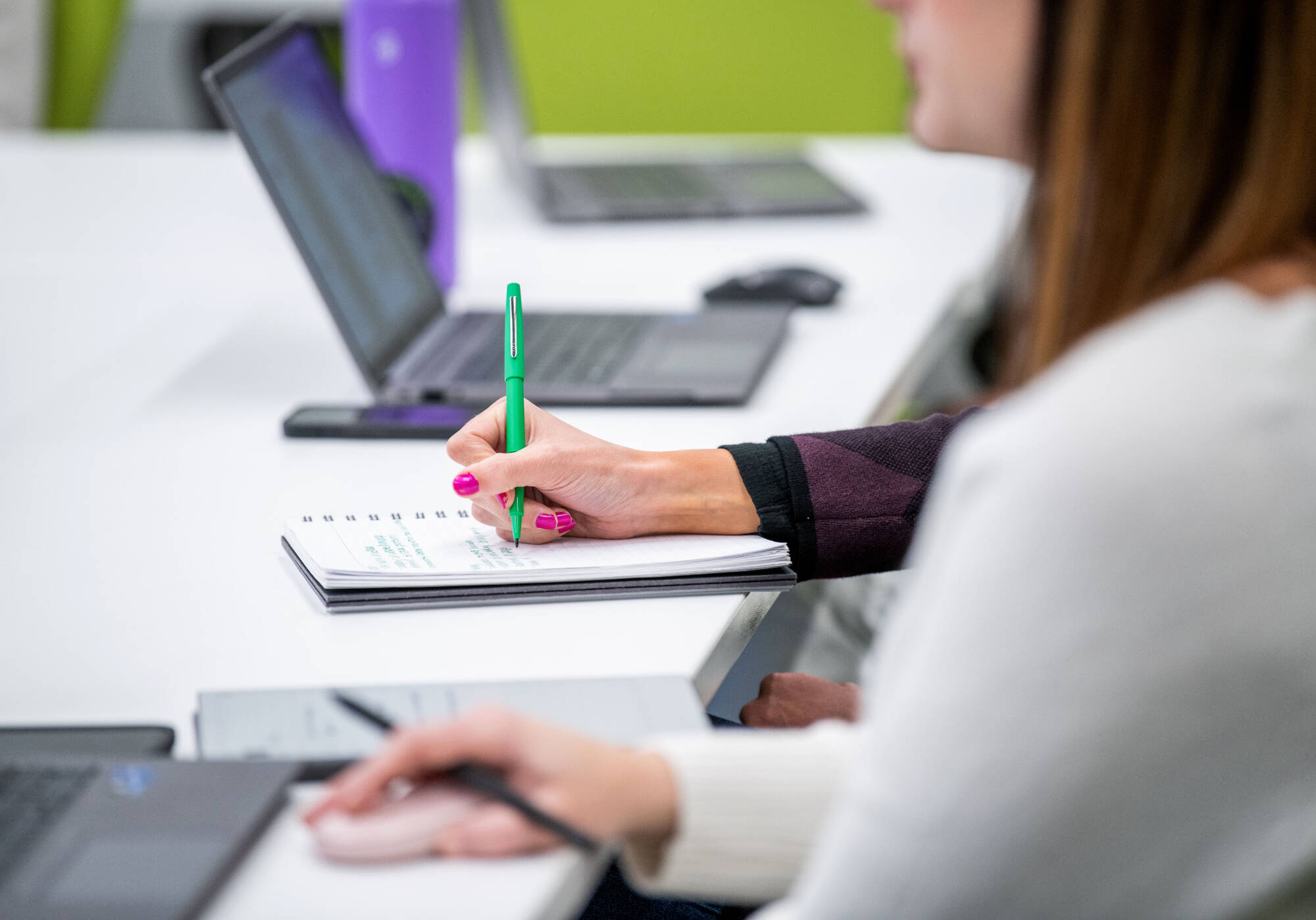 close up of students as they work on computers
